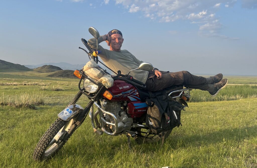 me chilling on my motorbike in the mongolian steppe