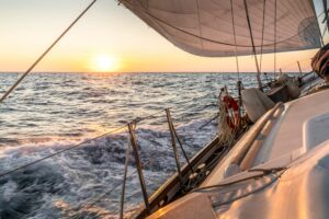 Sailboat, sailing across the atlantic with sunset