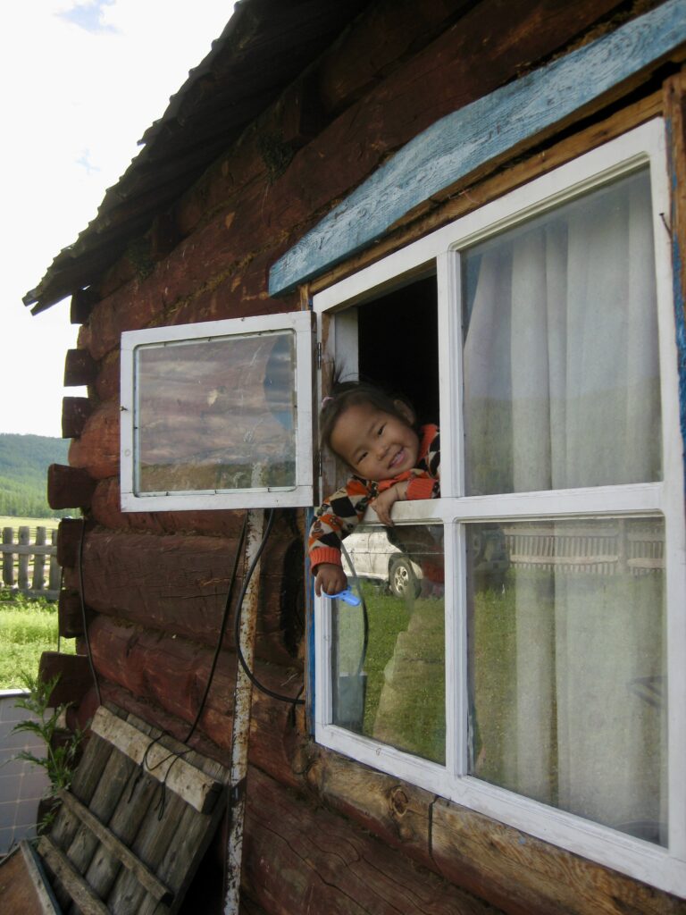 girl looking out of window mongolian steppe